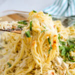 Spoonful of Italian Chicken Spaghetti with basil.