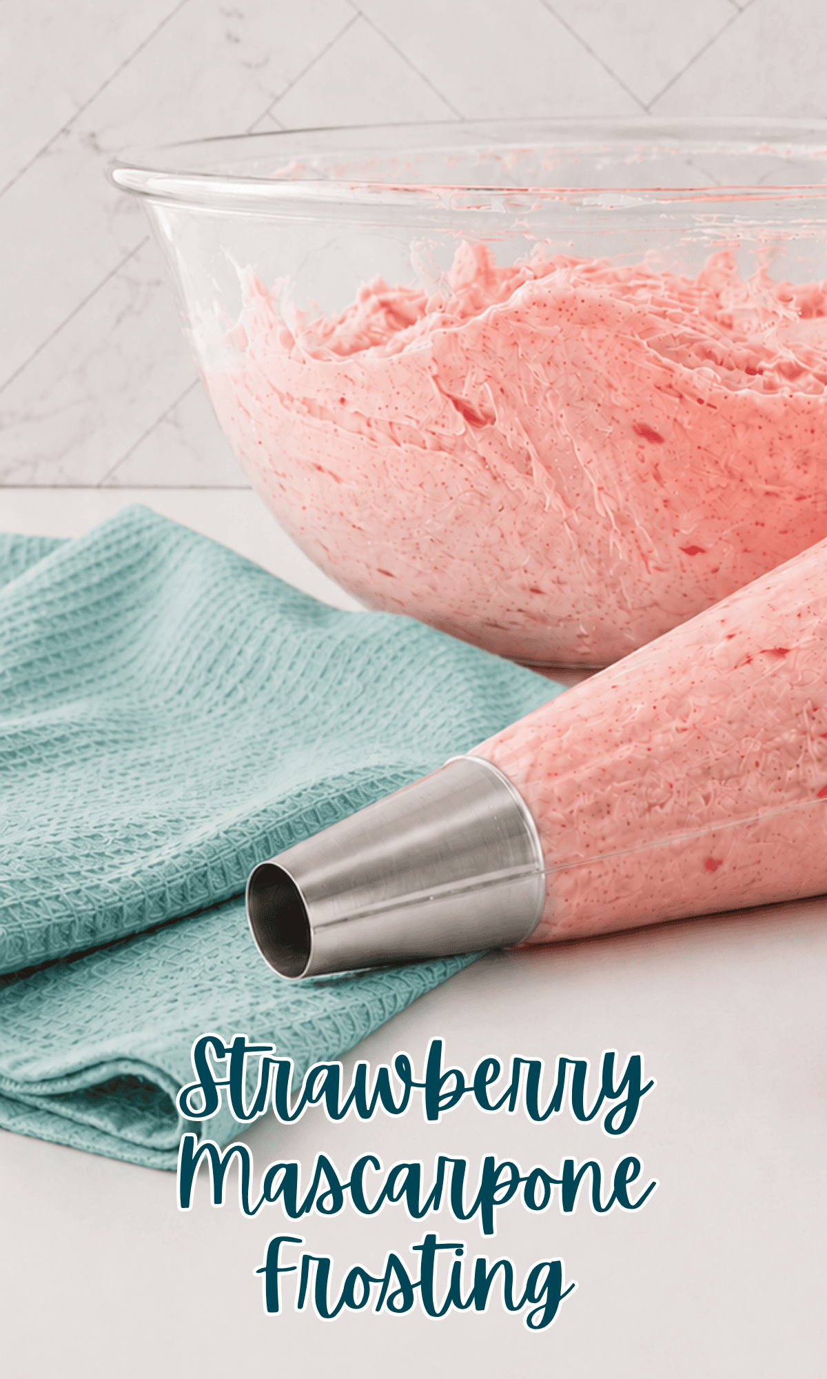 A bowl of pink fresh strawberry frosting sits behind a piping bag filled with the same frosting, placed on a teal textured cloth. The words “Strawberry Mascarpone Frosting” are overlaid at the bottom.