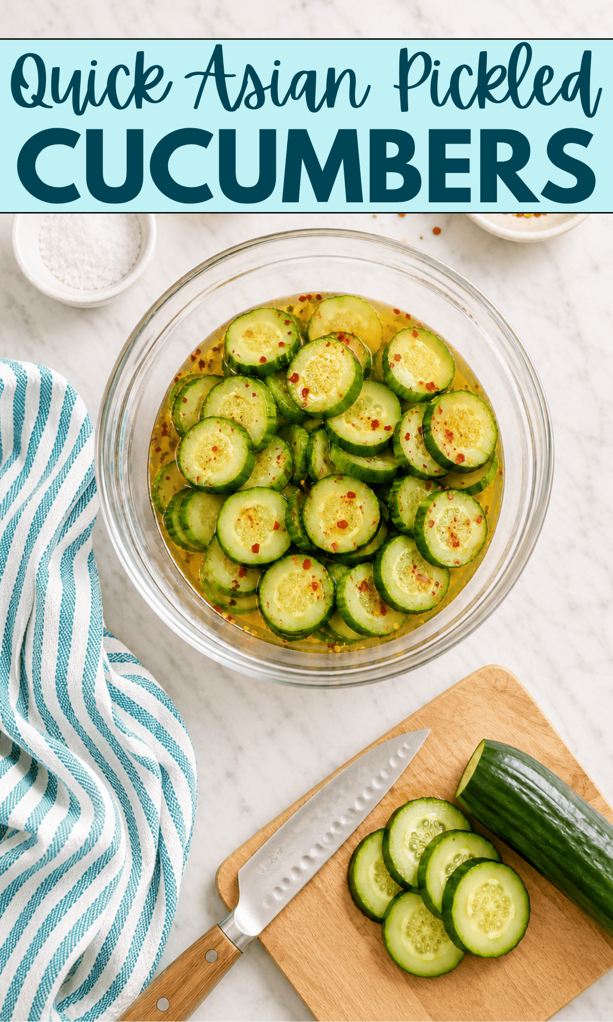 A bowl of sliced cucumbers in pickling liquid, sprinkled with red pepper flakes. Nearby are a cutting board with a partially sliced cucumber, a knife, a dish towel, and a small bowl of salt. Text reads: Quick Asian Pickled Cucumbers.